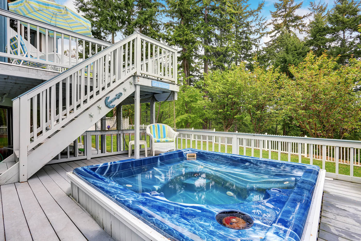 Large marine style home with two level deck. hot tub view