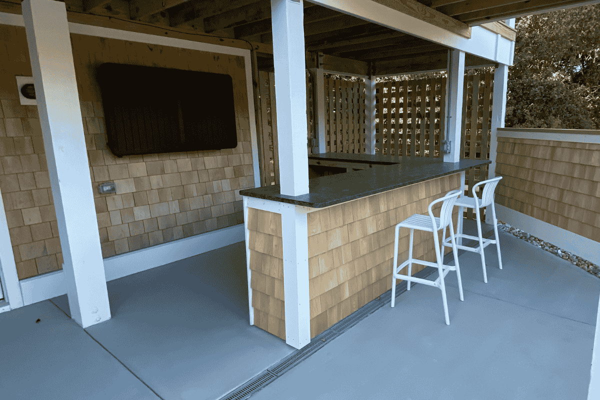 OBX house remodel exterior after renovation showing new siding, outdoor living space under a OBX rental for improved curb appeal for higher booking rates.